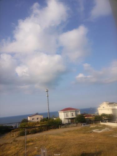 a view of a cloudy sky with houses and a field at HAMZAOĞLu KONAK in Atakum