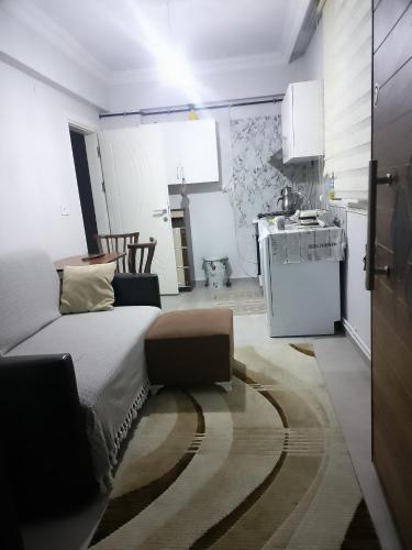 a bedroom with a large bed and a kitchen at HAMZAOĞLu KONAK in Atakum