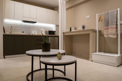 a kitchen with two stools and a table at Azilo Urban Suites in Kos Town
