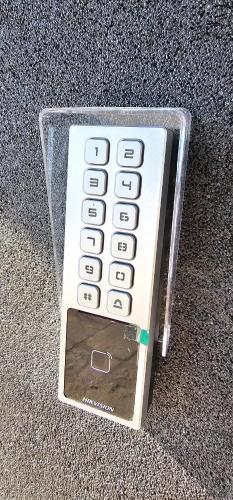 a remote control in a plastic case sitting on the floor at Platforma2b eco in Šiauliai
