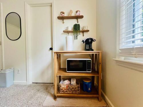 a microwave on a shelf in a room at Homey little Suite in Columbia TN in Columbia