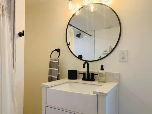 a bathroom with a sink and a mirror at Brand New Basement Apt with Hot Tub in Colorado Springs