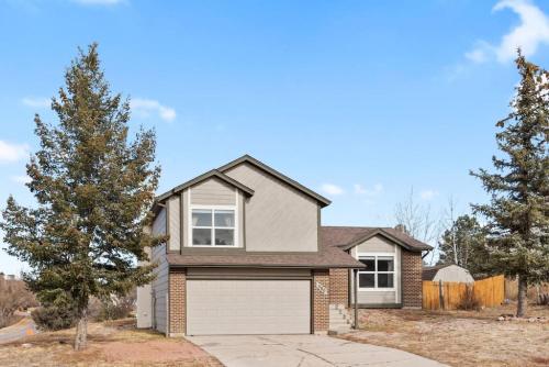 a brick house with a white garage at Beautiful Mountain Views Close to Hiking Trails in Monument
