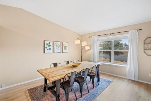 a dining room with a wooden table and chairs at Beautiful Mountain Views Close to Hiking Trails in Monument