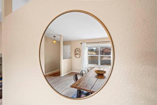 a mirror on a wall with a table and chairs at Beautiful Mountain Views Close to Hiking Trails in Monument