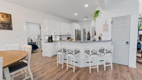 a kitchen with white cabinets and a table and chairs at Serene Escape by the Lake home in Montgomery