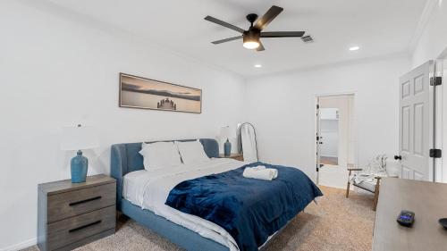 a bedroom with a bed and a ceiling fan at Serene Escape by the Lake home in Montgomery