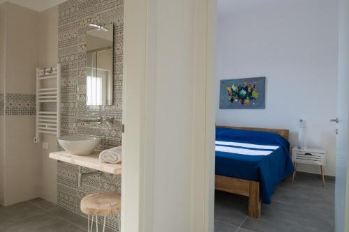 a bathroom with a bed and a sink and a mirror at Casa "Stella" - Locazioni Turistiche in Pulsano