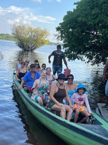 a group of people sitting in a boat on the water at Amazônia LODGE Exxperience in Manaus