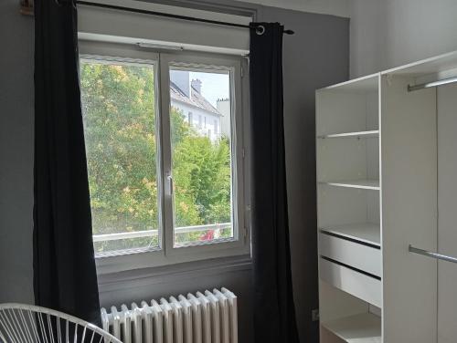 a window in a room with a radiator in front of it at Appartement 2 hyper centre Lorient in Lorient