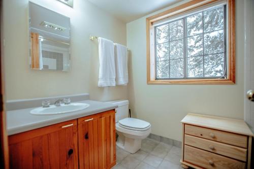 a bathroom with a toilet and a sink and a window at Cabin on the Edge of Forever in Brighton