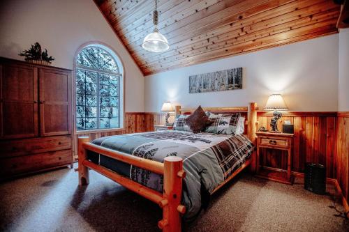a bedroom with a wooden bed and a window at Cabin on the Edge of Forever in Brighton