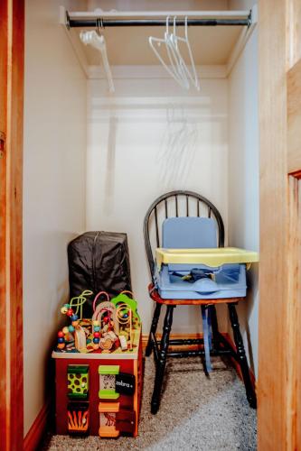 a desk and a chair in a room with toys at Cabin on the Edge of Forever in Brighton