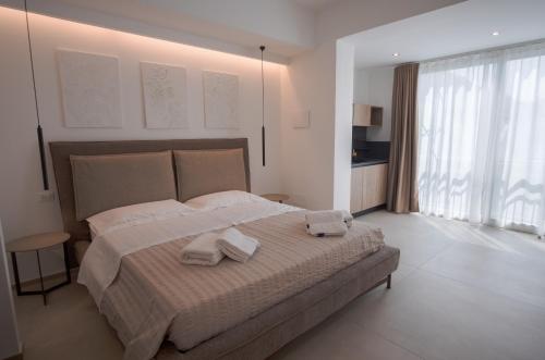 a bedroom with a large bed with two towels on it at B&B Le Muse in Mondello