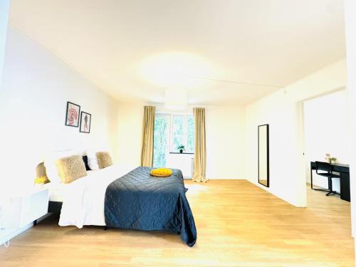a white bedroom with a bed and a desk at aday - Solsortvej Suite 3 Randers in Randers