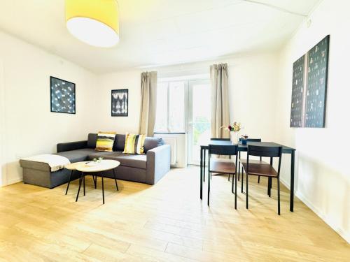 a living room with a couch and a table at aday - Solsortvej Suite 3 Randers in Randers