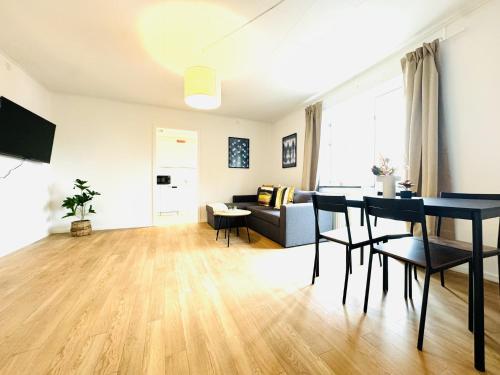 a living room with a table and a couch at aday - Solsortvej Suite 3 Randers in Randers