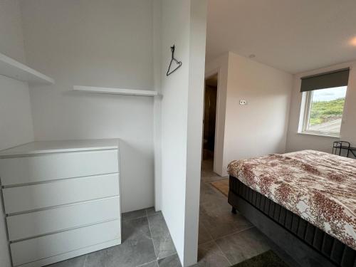 a bedroom with a bed and a window at Mossberg Luxury 3 bedroom Villa in Selfoss