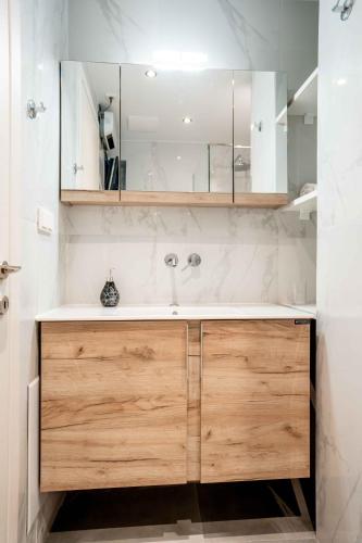 a bathroom with a sink and a mirror at The Nightingale in Ioannina