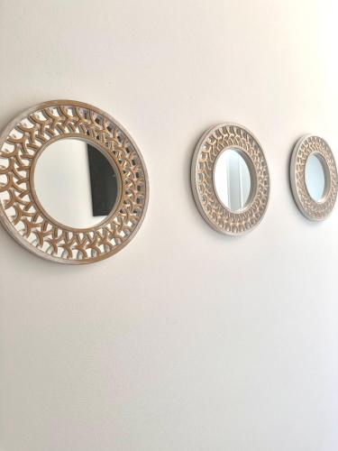 two circular mirrors on a wall with at Vila Vista Verde in Zaklopača
