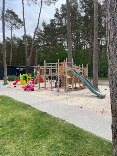 a playground with a slide in a park at Seaside Harmony in Pogorzelica