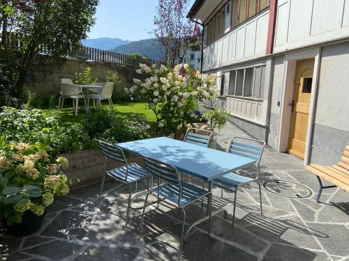 a blue table and chairs on a patio at Ferienwohnung Bärli Appenzell in Appenzell