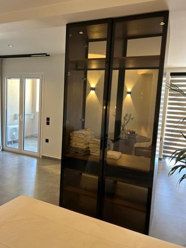 a room with a glass cabinet with towels in it at X luxury suites in Argostoli
