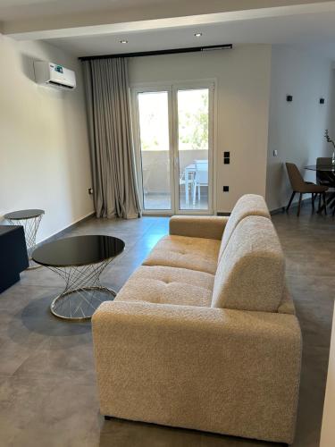 a living room with a couch and a table at X luxury suites in Argostoli