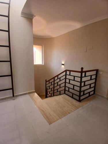an empty room with a staircase in a house at Mountain View Sokhna 1, Villa 4 Bedrooms, Direct to Pool, 300 M to Beach & Dayra Camp, Families ONLY in Ain Sokhna