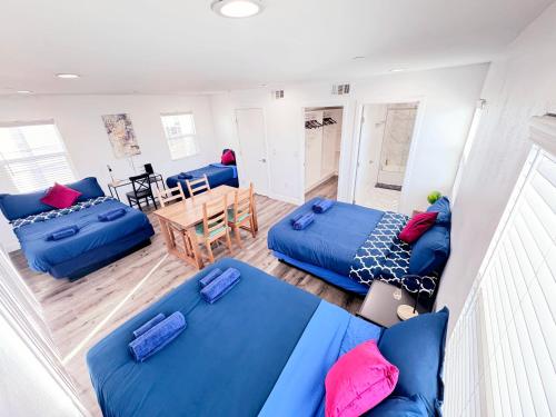 a living room with blue couches and a table at Cozy 3 BR Townhouse with Balcony in Los Angeles