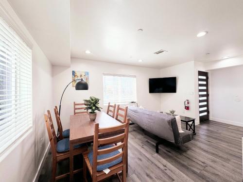 a dining room with a table and a couch at Cozy 3 BR Townhouse with Balcony in Los Angeles