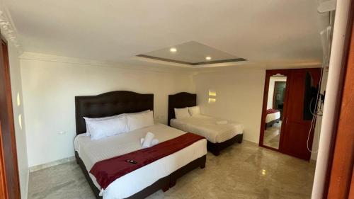 Ένα ή περισσότερα κρεβάτια σε δωμάτιο στο Hotel Puente Piedra