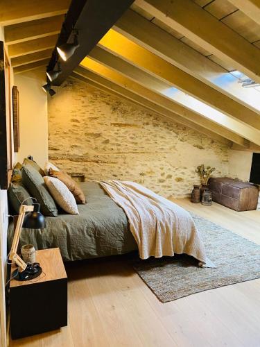 a bedroom with a bed and a brick wall at Villa Age con chimenea in Age