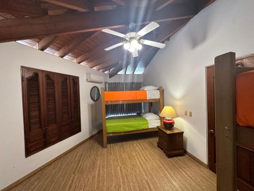 1 dormitorio con ventilador de techo y litera en Casa de Campo Condominio El Pueblo-Santa Clara,Ate, en Lima