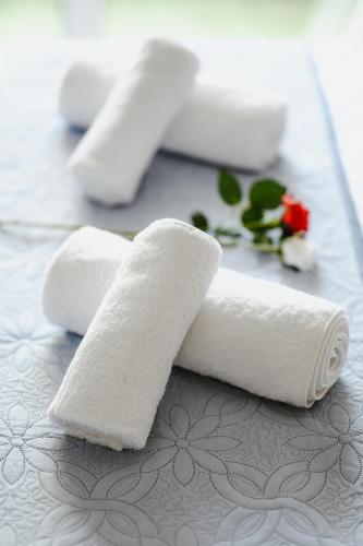 a group of white rolled towels on a table at Elysium in Volos