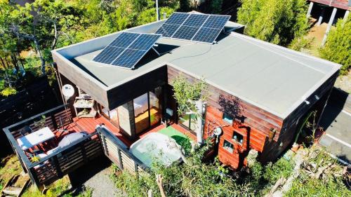 an aerial view of a house with solar panels on the roof at Cabaña del Bosque in Pichilemu