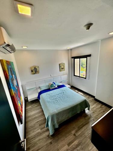 a bedroom with a bed and a window at Luxury Condo at Jaco Bay, Costa Rica's best beach in Jacó