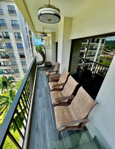 a row of chairs on a balcony of a building at Luxury Condo at Jaco Bay, Costa Rica's best beach in Jacó