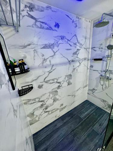 a bathroom with a white marble wall at Luxury Condo at Jaco Bay, Costa Rica's best beach in Jacó