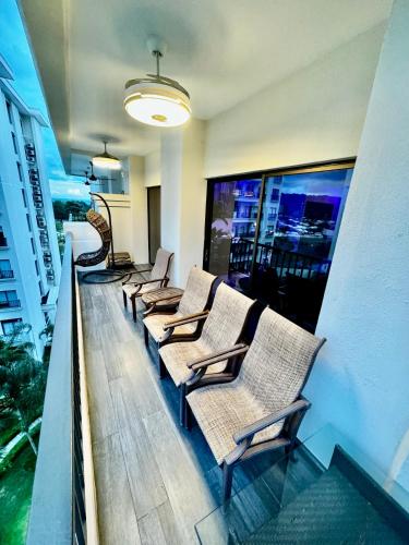 a row of chairs sitting on a balcony at Luxury Condo at Jaco Bay, Costa Rica's best beach in Jacó