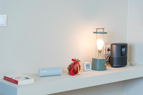 a shelf with a coffee maker and a lamp on it at Thea Sea View Kefalonia in Sarlata