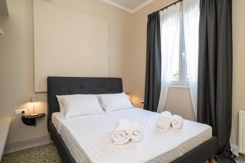 a bedroom with a bed with two towels on it at Thea Sea View Kefalonia in Sarlata
