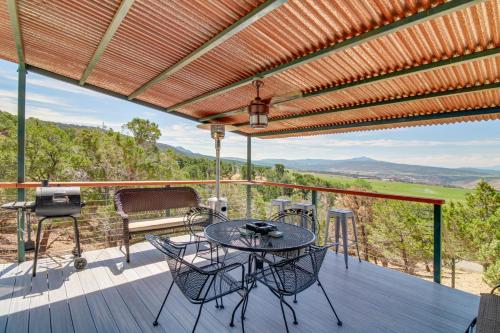 a patio with a table and chairs on a deck at Mountainside Yurt with Views Less Than 3 Mi to Black Canyon! in Montrose