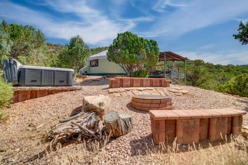 a backyard with a trailer and a bench and a building at Mountainside Yurt with Views Less Than 3 Mi to Black Canyon! in Montrose