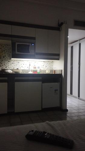 a kitchen with a sink and a microwave at Flat Gold Beach in Recife