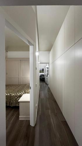 an empty room with a bed and a hallway at Suite Piazza del Popolo in Ascoli Piceno