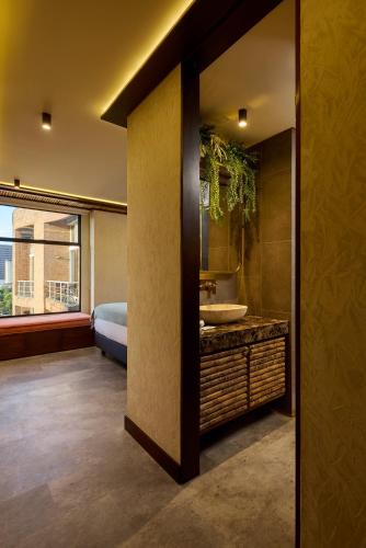 a bathroom with a sink and a mirror at Golden Valley Hotel in Medellín