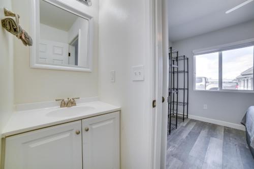 a bathroom with a sink and a mirror at Renovated Hawthorne Apartment By Museums and Dining! in Hawthorne