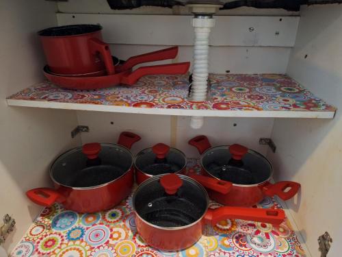 a kitchen with four pots on a counter with a sink at Casa Alto Da Boa Vista Com Piscina e Churrasqueira in São Paulo