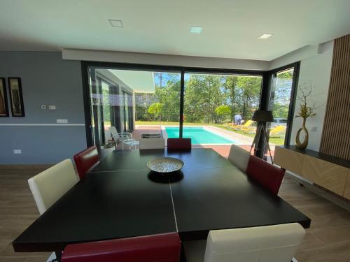 a dining room with a table and chairs and a pool at Casa tapada da cheda 1 in Fafe
